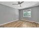 Bedroom with gray walls, hardwood floors, and a window overlooking trees at 2752 Poplar Rd, Sharpsburg, GA 30277