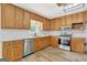 Renovated kitchen featuring wood cabinets, granite countertops, and stainless steel appliances at 2752 Poplar Rd, Sharpsburg, GA 30277