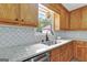 Modern kitchen with granite countertops, updated sink, and wood cabinets at 2752 Poplar Rd, Sharpsburg, GA 30277