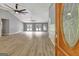 Bright living room with hardwood floors, vaulted ceiling, and two ceiling fans at 2752 Poplar Rd, Sharpsburg, GA 30277