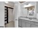 Bathroom with granite countertop, gray cabinets, and a walk-in closet at 2752 Poplar Rd, Sharpsburg, GA 30277