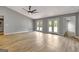 Large living room with hardwood floors, vaulted ceiling, and French doors at 2752 Poplar Rd, Sharpsburg, GA 30277