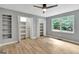 Bright bedroom with neutral walls, hardwood floors, and built-in shelving at 2752 Poplar Rd, Sharpsburg, GA 30277