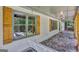 Covered front porch with stone flooring, wooden swing, and wooded views at 2752 Poplar Rd, Sharpsburg, GA 30277