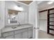 Bathroom with granite countertop, gray cabinets, and a walk-in closet at 2752 Poplar Rd, Sharpsburg, GA 30277
