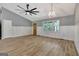 Open living room with hardwood floors, vaulted ceiling, and wainscoting at 2752 Poplar Rd, Sharpsburg, GA 30277