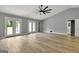 Open concept living room with hardwood floors, vaulted ceiling, and access to backyard at 2752 Poplar Rd, Sharpsburg, GA 30277