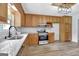 Kitchen with wood cabinets, granite countertops, and stainless steel appliances at 2752 Poplar Rd, Sharpsburg, GA 30277