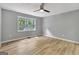 Bedroom with gray walls, hardwood floors, and a large window at 2752 Poplar Rd, Sharpsburg, GA 30277