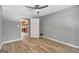 Bedroom with gray walls, hardwood floors, and access to kitchen at 2752 Poplar Rd, Sharpsburg, GA 30277