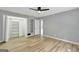 Bedroom with built-in shelving and wood-look floors at 2752 Poplar Rd, Sharpsburg, GA 30277