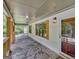 Spacious covered porch with stone flooring, wooden swing, and access to front door at 2752 Poplar Rd, Sharpsburg, GA 30277