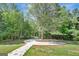 Landscaped front yard with a circular driveway and large tree at 2752 Poplar Rd, Sharpsburg, GA 30277