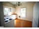 Simple kitchen with white cabinets, wood floors, and a stove at 10 Maranatha Rd, Mcdonough, GA 30252