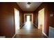 Long hallway with hardwood floors and doors at 10 Maranatha Rd, Mcdonough, GA 30252
