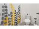 Simple bathroom with toilet, shower, and patterned curtain at 104 Montgomery Dr, Stockbridge, GA 30281