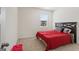 Bright bedroom with red bedding and a large window at 104 Montgomery Dr, Stockbridge, GA 30281