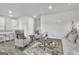 Bright living room with comfy seating, stylish rug and a view into the kitchen at 114 Jacoby Dr # 111, Fairburn, GA 30213