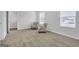 Spacious bedroom with neutral carpeting and two accent chairs at 114 Jacoby Dr # 111, Fairburn, GA 30213