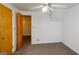 Bright bedroom with ceiling fan, neutral carpet, and double closets at 489 Martin Rd, Stone Mountain, GA 30088