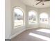 Bright bedroom featuring three arched windows and neutral carpeting at 230 Waltham Way, Fayetteville, GA 30214