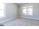 Spacious bedroom with neutral carpeting and two large windows at 230 Waltham Way, Fayetteville, GA 30214