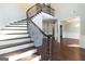 Elegant curved staircase with wrought iron railing at 230 Waltham Way, Fayetteville, GA 30214
