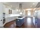 Modern kitchen with white cabinets, a large island, and stainless steel appliances at 230 Waltham Way, Fayetteville, GA 30214