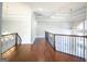 Elegant hallway with hardwood floors and iron railing at 230 Waltham Way, Fayetteville, GA 30214