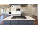 Kitchen island with gas cooktop and stainless steel range hood at 230 Waltham Way, Fayetteville, GA 30214