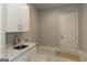 Laundry room with white cabinets and sink at 230 Waltham Way, Fayetteville, GA 30214
