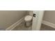Small bathroom with toilet and grey tiled floor at 230 Waltham Way, Fayetteville, GA 30214