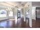 Open entryway showcasing hardwood floors, a staircase, and views to the dining room at 230 Waltham Way, Fayetteville, GA 30214