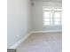 Spacious bedroom with neutral carpeting and two large windows at 230 Waltham Way, Fayetteville, GA 30214