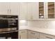 White kitchen cabinets and quartz countertops at 230 Waltham Way, Fayetteville, GA 30214