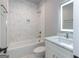 Modern bathroom with marble tile and updated fixtures at 230 Waltham Way, Fayetteville, GA 30214