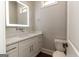 Bathroom with a modern vanity and a lit mirror at 230 Waltham Way, Fayetteville, GA 30214