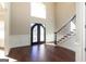Grand entryway with curved staircase and hardwood floors at 230 Waltham Way, Fayetteville, GA 30214