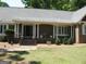 Brick ranch house with a covered porch and landscaping at 295 Camelot Dr, Fayetteville, GA 30214