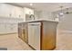 Kitchen island with stainless steel dishwasher and ample storage at 406 Lowery Rd, Grantville, GA 30220