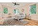 Cozy bedroom with hardwood floors, large windows, and ceiling fan at 1055 Church St, Smyrna, GA 30080