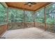 Relaxing screened porch with wooden deck and ceiling fan, overlooking a lush wooded area at 1055 Church St, Smyrna, GA 30080
