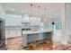 Modern kitchen with white cabinets, marble island, and hardwood floors at 1055 Church St, Smyrna, GA 30080