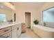 Modern bathroom with soaking tub, walk-in shower, and dual vanity at 1055 Church St, Smyrna, GA 30080