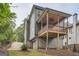 Home features a large deck, attached garage and driveway at 1055 Church St, Smyrna, GA 30080