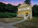 Two-story yellow house with front porch and steps at 321 Seventh Ave, Scottdale, GA 30079