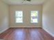 Bright bedroom with hardwood floors and two large windows at 321 Seventh Ave, Scottdale, GA 30079
