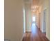 Long hallway with light walls and hardwood floors at 321 Seventh Ave, Scottdale, GA 30079