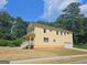 Two-story yellow house, side view showcasing garage at 321 Seventh Ave, Scottdale, GA 30079