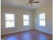 Spacious bedroom with hardwood floors and three windows at 321 Seventh Ave, Scottdale, GA 30079